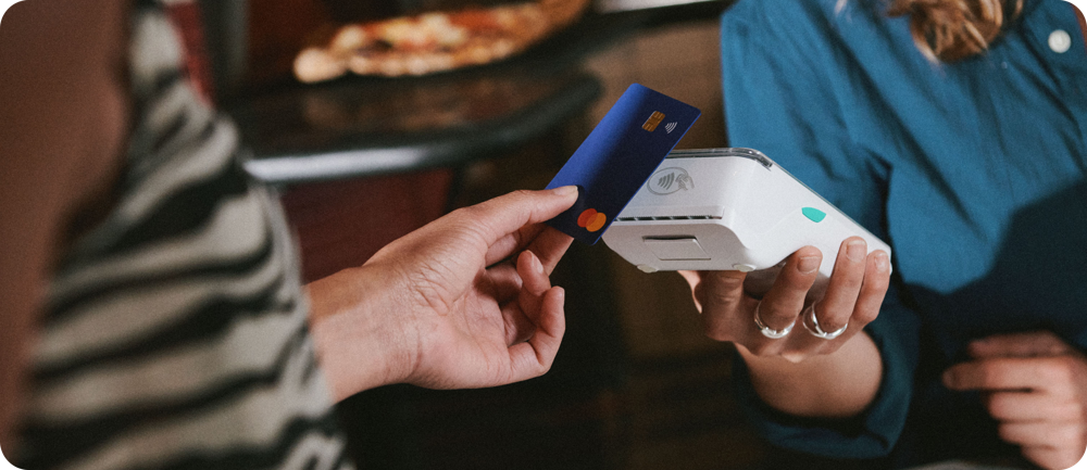 Customer paying contactlessly on a Dojo Go portable card machine