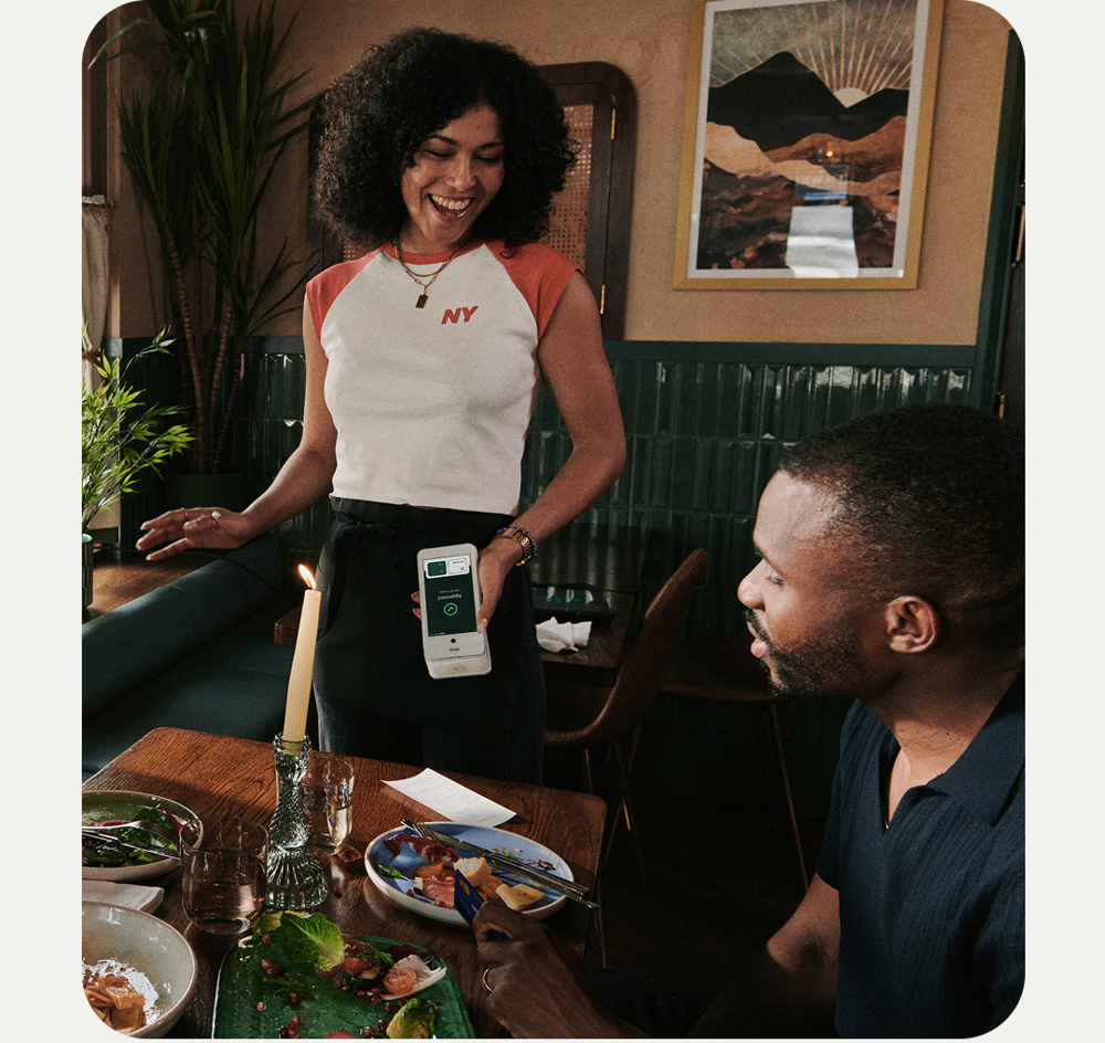 Dojo Go card machine being used in a busy restaurant
