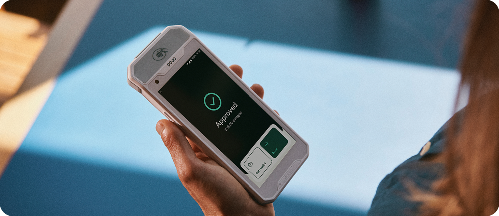 Close-up of a Dojo Pocket handheld card machine in use